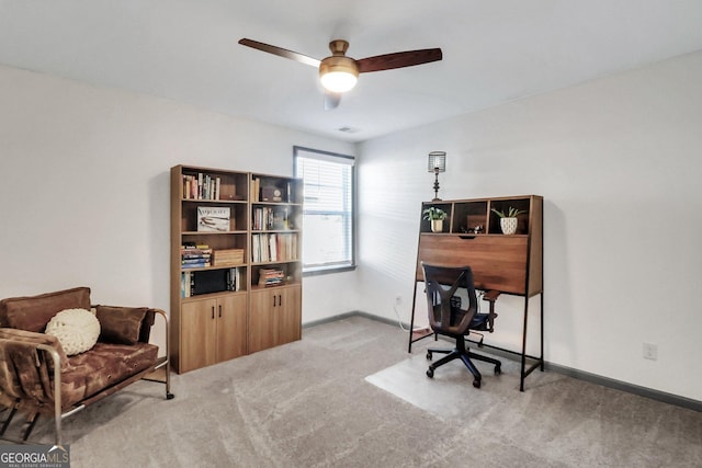 home office featuring ceiling fan and light colored carpet