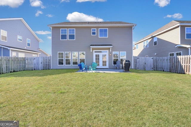 back of house with a yard and a patio