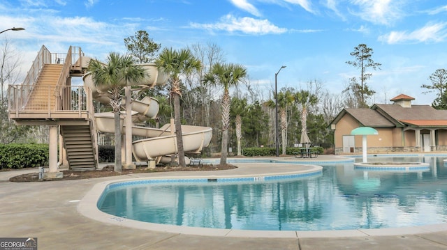 view of pool with a hot tub