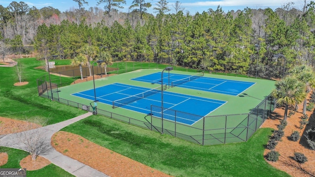 view of sport court featuring a lawn