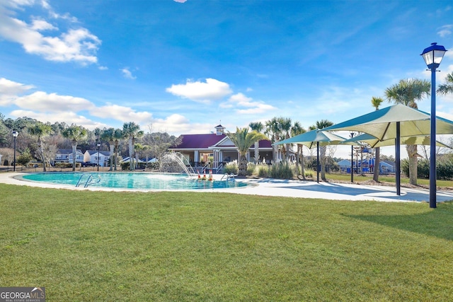 view of swimming pool featuring a yard and pool water feature