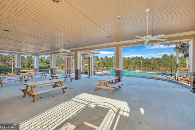 view of patio / terrace featuring a water view and ceiling fan