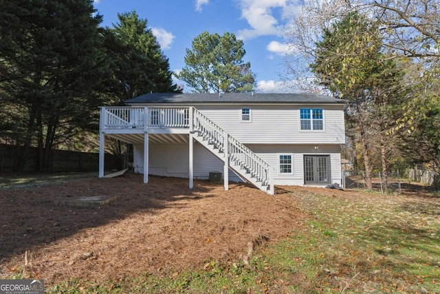 rear view of house with central air condition unit, french doors, and a deck