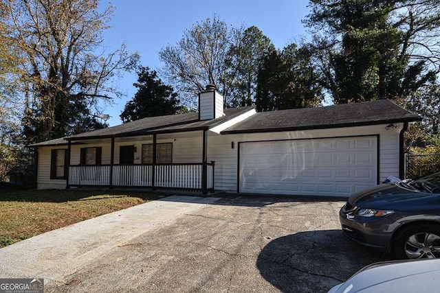 single story home featuring covered porch and a garage