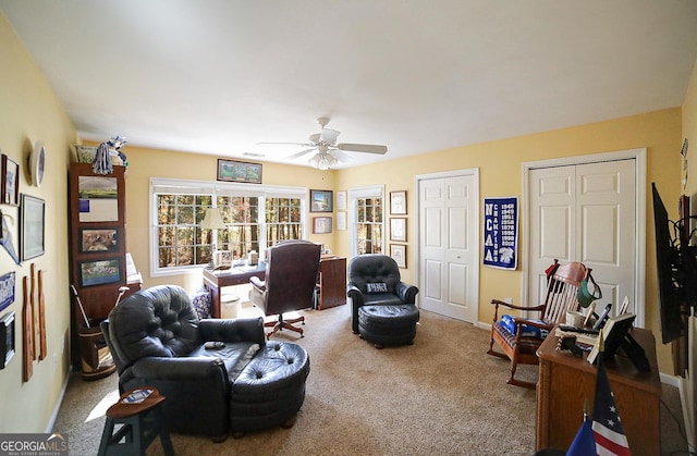 living room with ceiling fan and carpet floors