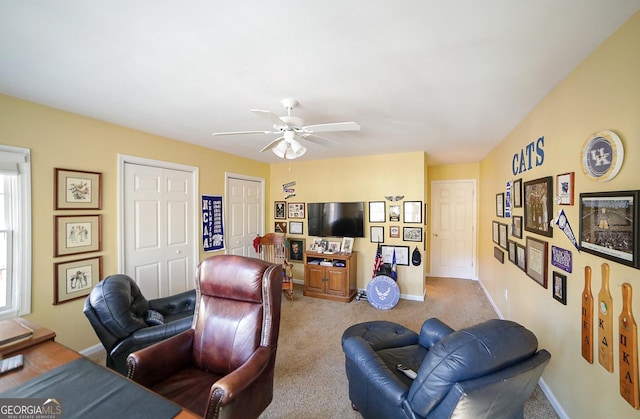 living room with ceiling fan and carpet floors