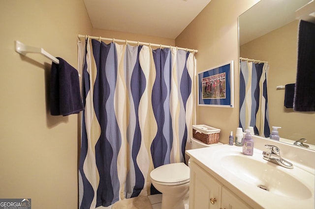 bathroom featuring tile patterned floors, vanity, and toilet