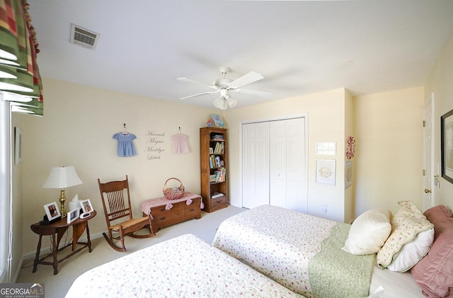 carpeted bedroom featuring a closet and ceiling fan