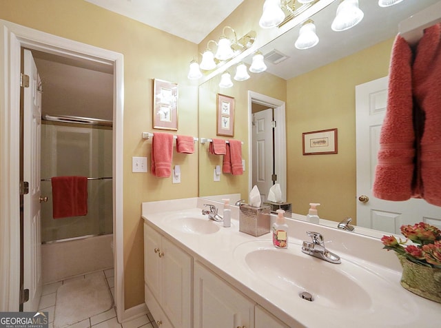 bathroom featuring tile patterned flooring, vanity, and combined bath / shower with glass door