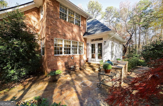 rear view of property with a patio area and french doors