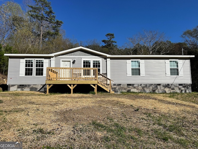 back of property featuring crawl space and a wooden deck