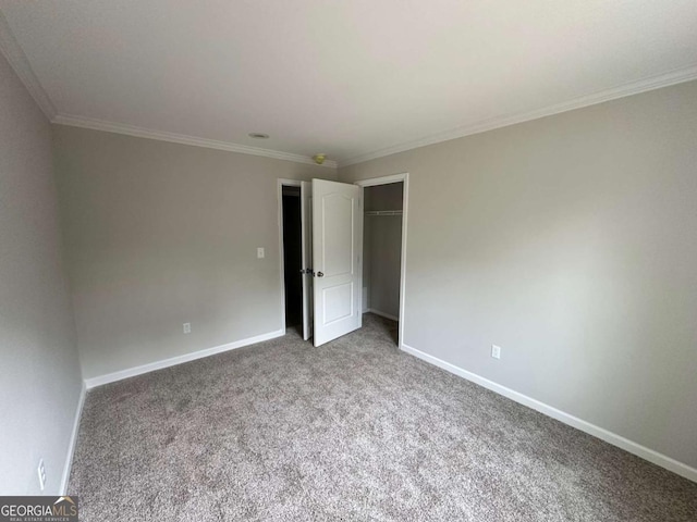 unfurnished bedroom featuring carpet flooring, ornamental molding, and baseboards