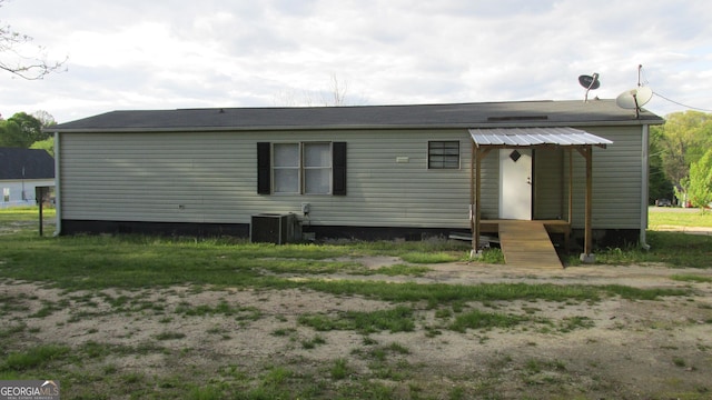 rear view of property with cooling unit