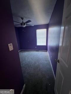 carpeted spare room featuring ceiling fan