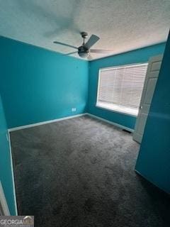 spare room featuring a textured ceiling, carpet floors, and ceiling fan