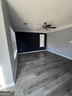 spare room featuring a textured ceiling, ceiling fan, and dark hardwood / wood-style floors