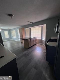 kitchen with dark hardwood / wood-style flooring and a center island