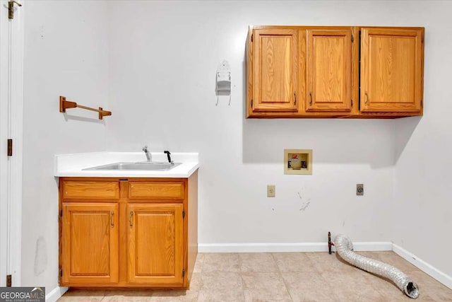 washroom featuring sink, hookup for a washing machine, cabinets, and hookup for an electric dryer