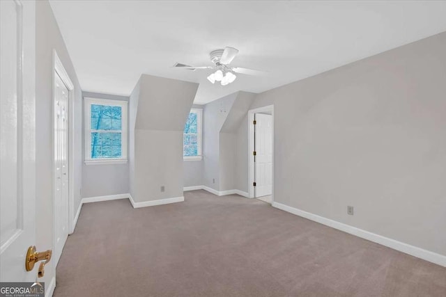 additional living space featuring carpet flooring, ceiling fan, and vaulted ceiling