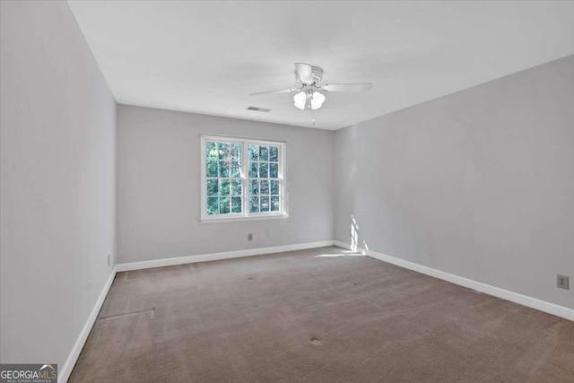 empty room featuring carpet flooring and ceiling fan