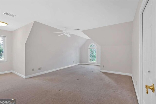 bonus room with carpet flooring, ceiling fan, and vaulted ceiling