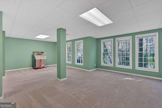 interior space featuring carpet flooring and a drop ceiling