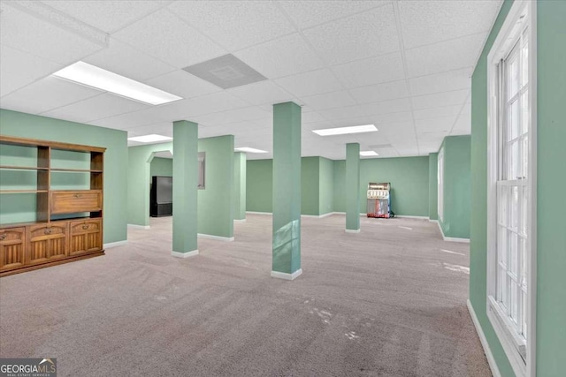 basement with light carpet and a drop ceiling