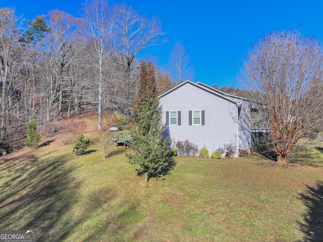 view of property exterior with a yard