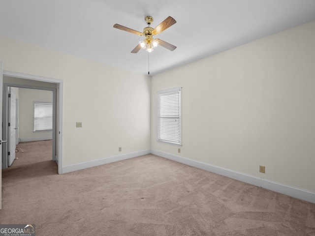 carpeted empty room featuring plenty of natural light and ceiling fan