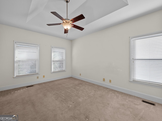 carpeted spare room with ceiling fan and lofted ceiling