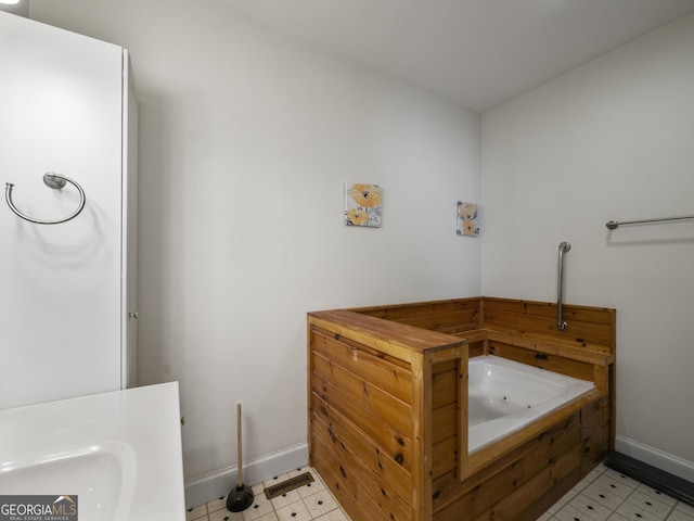 bathroom with a tub to relax in