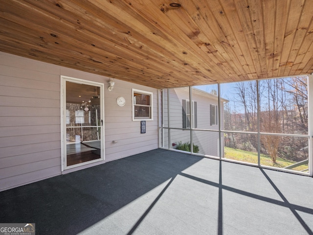 unfurnished sunroom with wooden ceiling