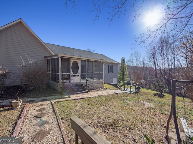 back of house featuring a sunroom