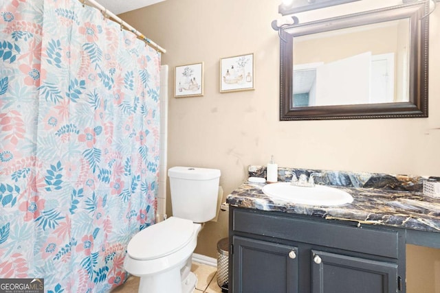 bathroom with tile patterned floors, vanity, curtained shower, and toilet