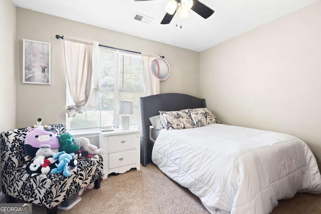 bedroom featuring ceiling fan and light carpet