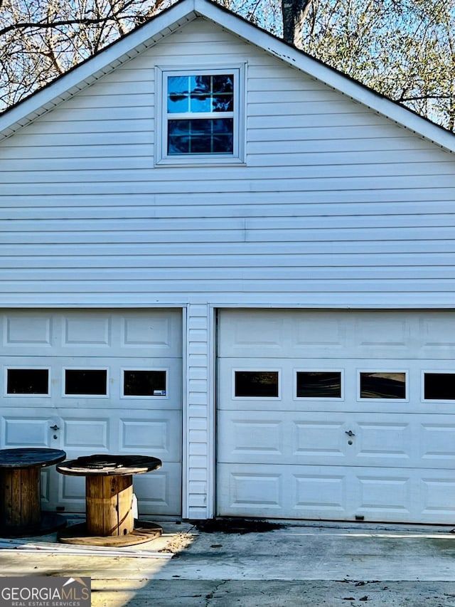 view of property exterior featuring a garage and an outdoor structure