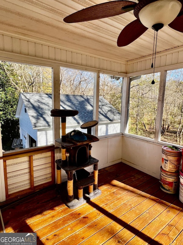 sunroom / solarium featuring ceiling fan and wood ceiling