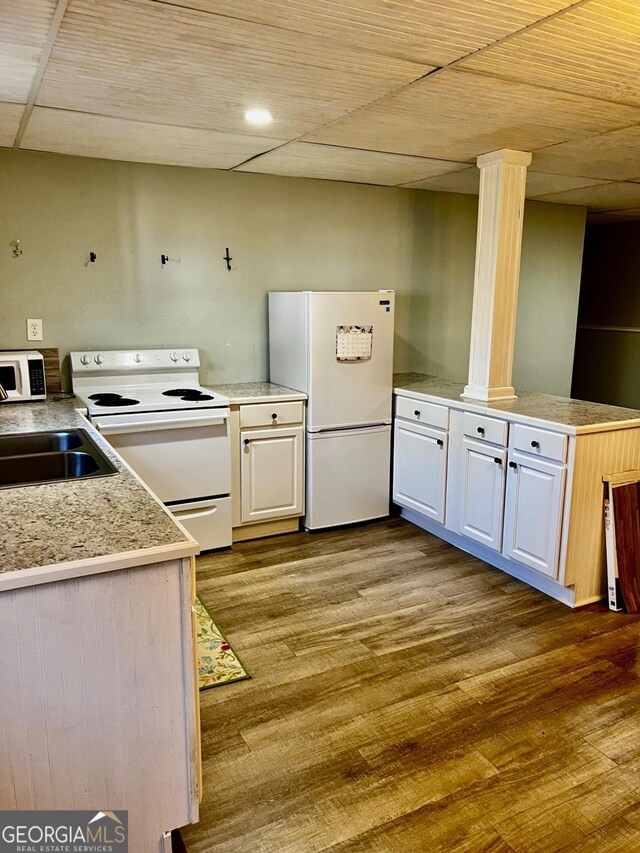 kitchen with white cabinetry, light wood-type flooring, white appliances, and sink