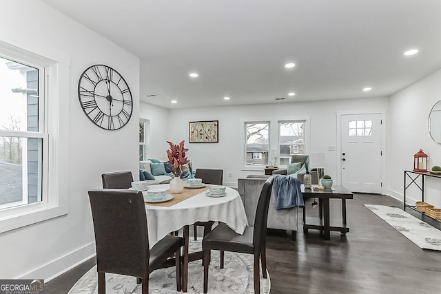 dining area featuring dark wood-type flooring