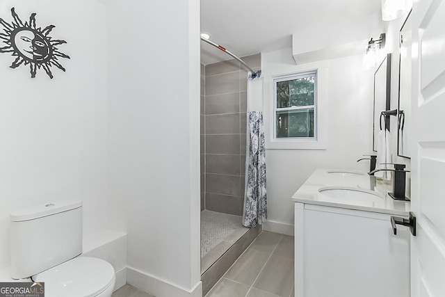 bathroom featuring a shower with shower curtain, vanity, toilet, and tile patterned floors