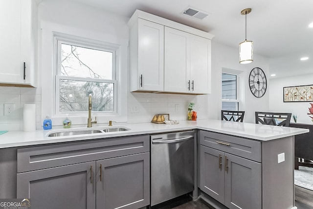 kitchen with gray cabinetry, white cabinetry, sink, stainless steel dishwasher, and kitchen peninsula