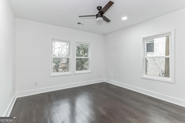 empty room featuring ceiling fan and dark hardwood / wood-style flooring