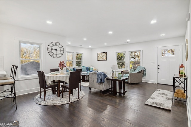 dining room featuring dark wood-type flooring and a wealth of natural light