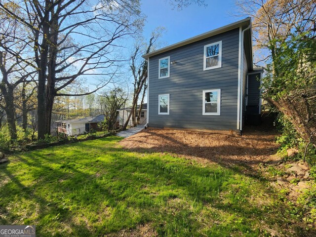 rear view of property featuring a yard