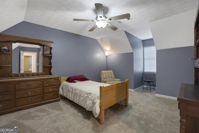 bedroom featuring a textured ceiling, light carpet, ceiling fan, and lofted ceiling