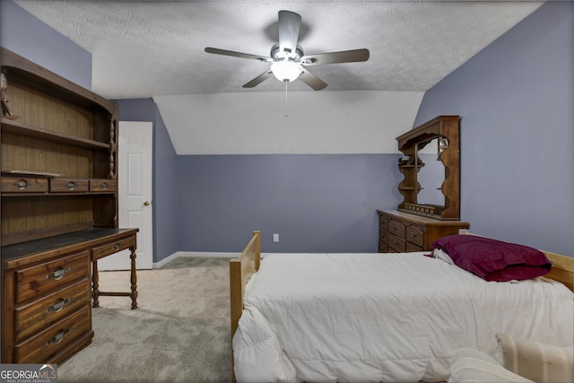 carpeted bedroom with a textured ceiling, ceiling fan, and vaulted ceiling