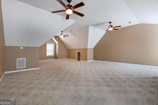 additional living space with light carpet, ceiling fan, and vaulted ceiling