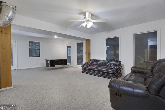 living room with ceiling fan and carpet