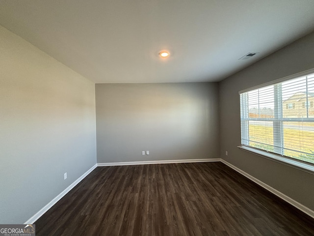 spare room with dark wood-type flooring