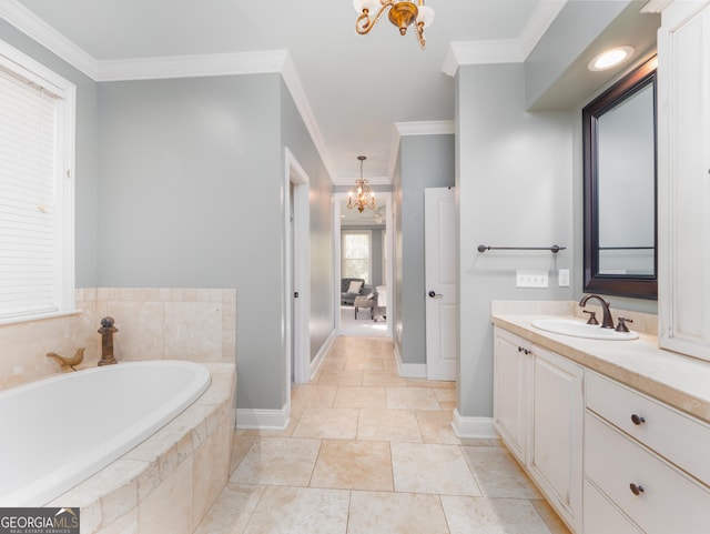 bathroom featuring vanity, crown molding, tiled tub, and an inviting chandelier